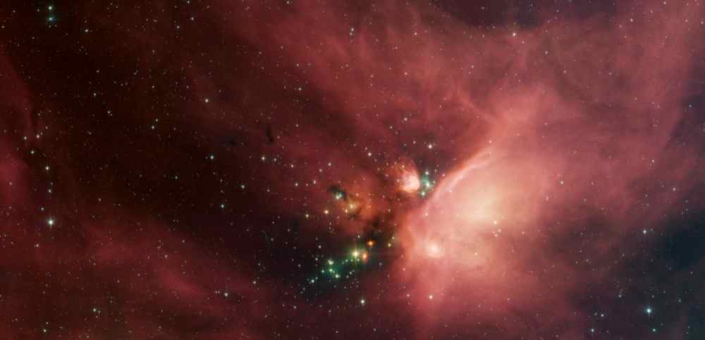 Newborn stars peek out from beneath their natal blanket of dust in this dynamic image of the Rho Ophiuchi dark cloud from NASA's Spitzer Space Telescope. This nebula is about 407 light years away from Earth.